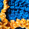 Just Because details Close-up of turquoise openwork knit and textured yellow trim