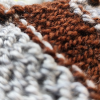 That’s How History Worked Out details (2) Close-up of grey and brown hand-knitted stripe texture